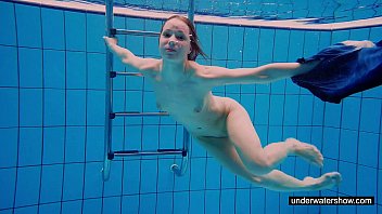 Teen girl Avenna is swimming in the pool