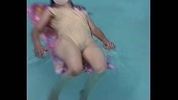 Girl on her back in wet seethrough swimsuit
